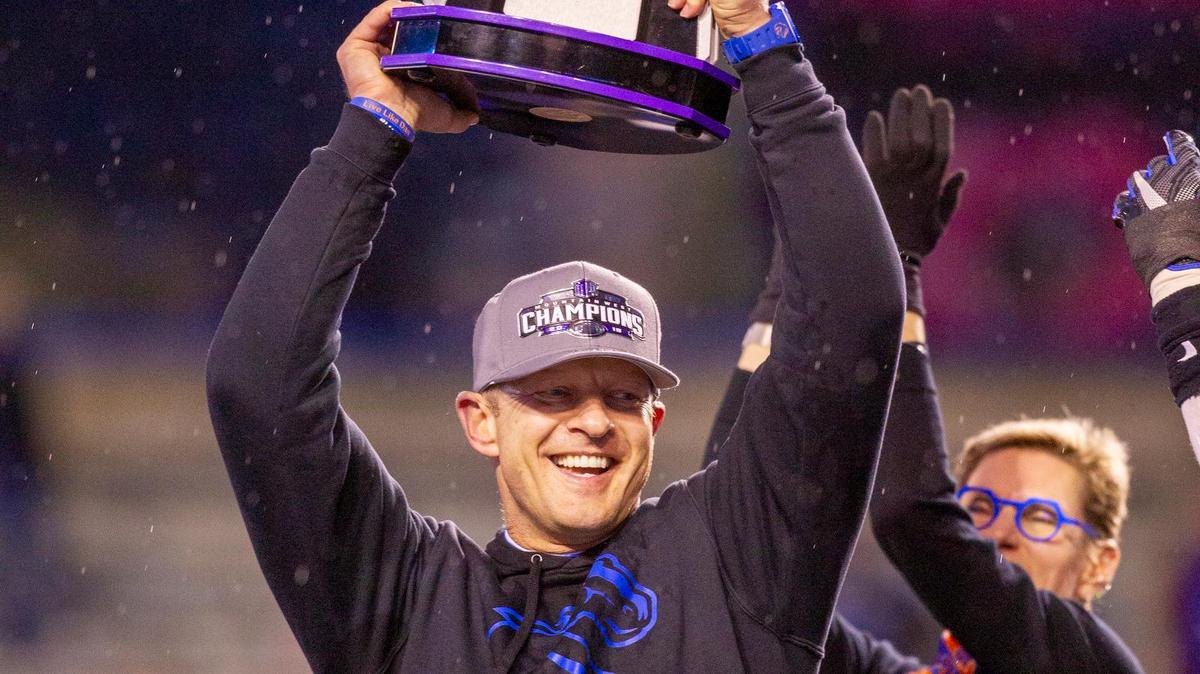 Boise State football coach Bryan Harsin holds the Mountain West championship trophy in December 2019 after the Broncos’ 31-10 win against Hawaii at Albertsons Stadium.