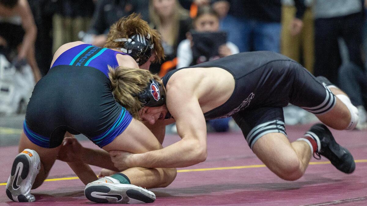 Nampa’s Carson Exferd, right, edged Century’s Kolter Burton, left, in the match of the day in the 138-pound championship Saturday at the Rollie Lane Invitational at the Ford Idaho Center in Nampa.