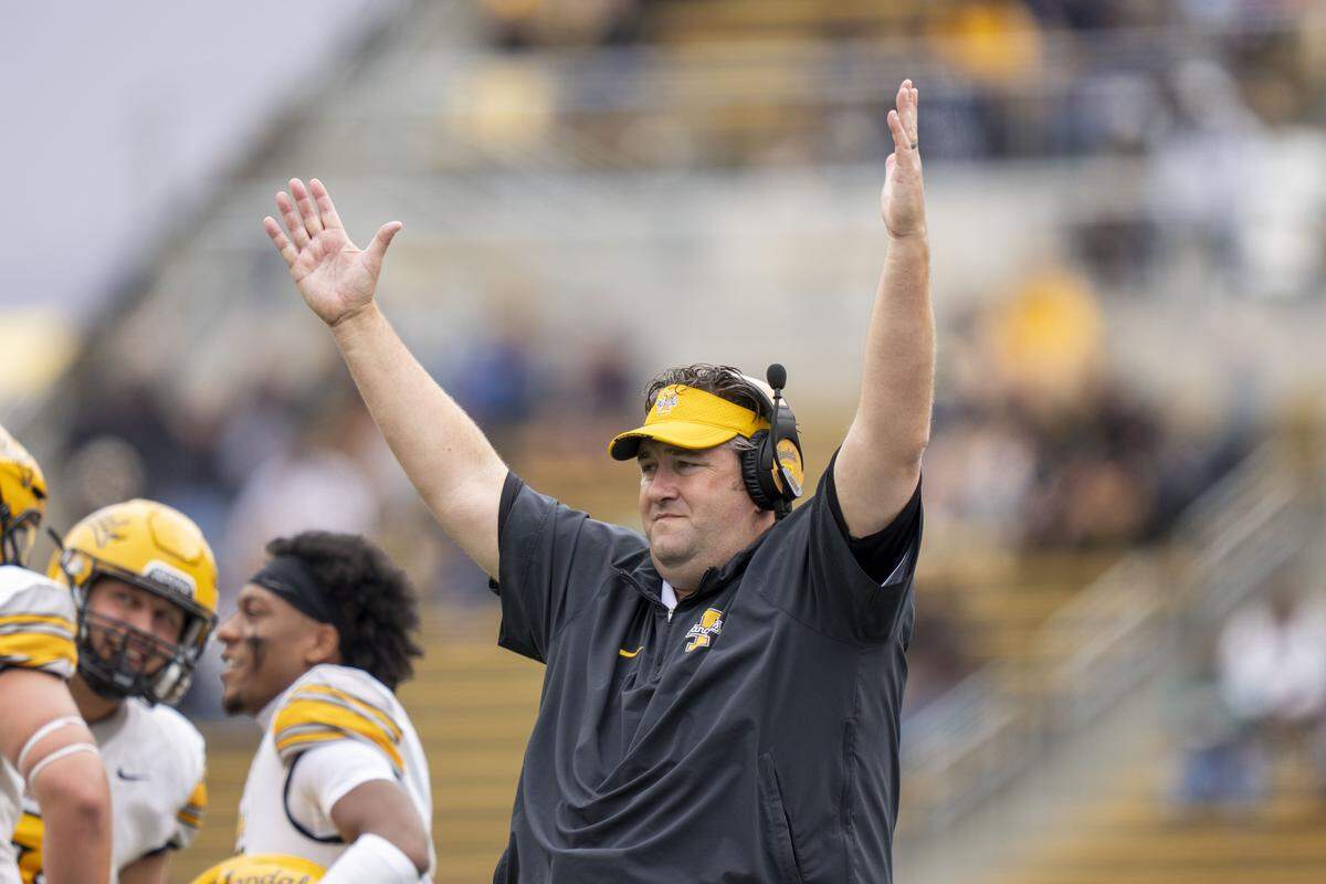 Former Idaho head coach Jason Eck signals touchdown against Cal during the first quarter of a Vandals game there in 2023.