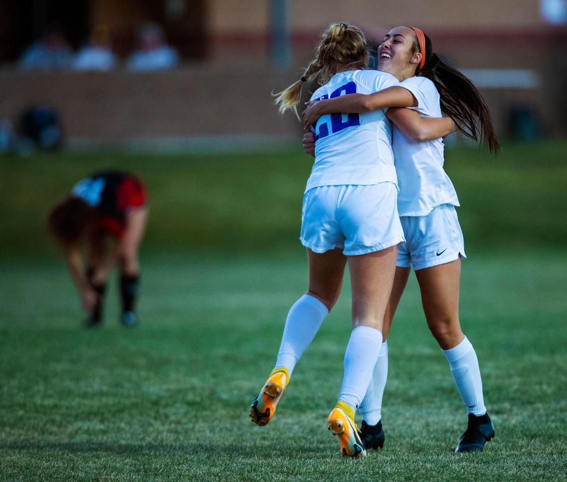 Rocky Mountain forward Nadia Kincaid, right, gets a hug from teammate Myalia Carver after scoring in the 2nd minute during the 5A state championship game Tuesday at Middleton High School.