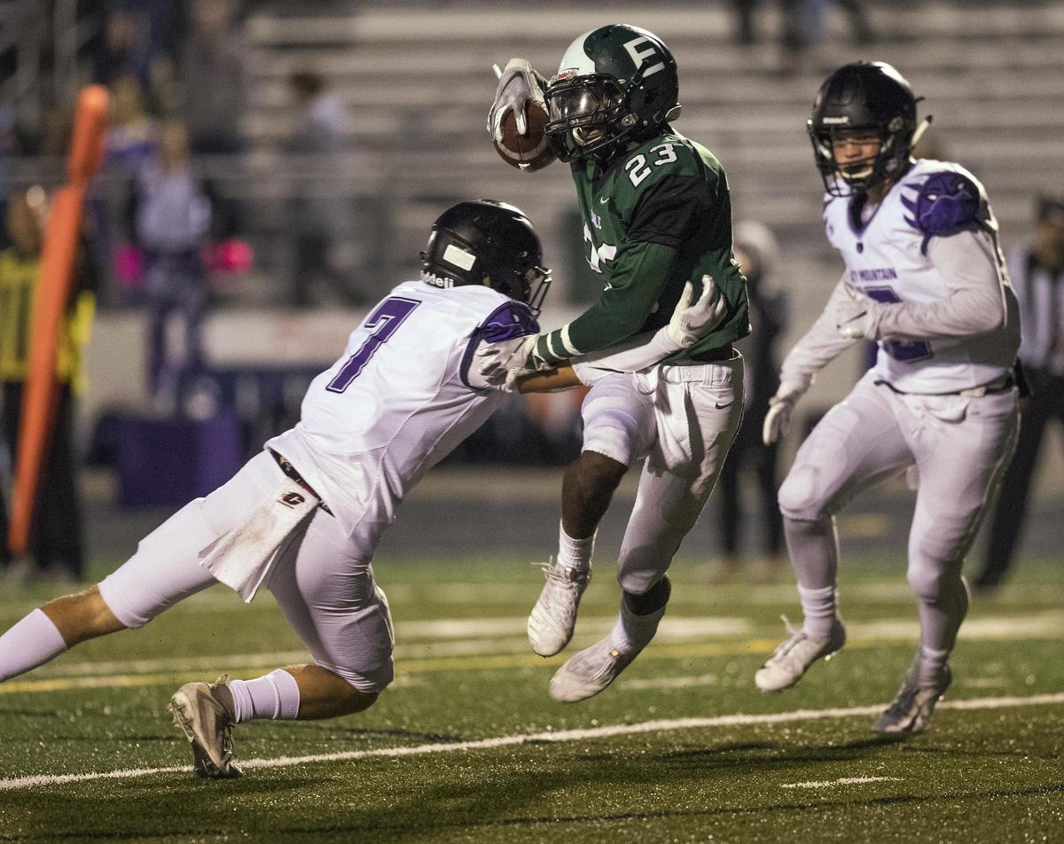 Eagle defensive back Bridger Marboe looks for running room after an interception as Rocky Mountain receivers Kaden Birch (7) and Conner Croft pursue him Oct. 4 at Eagle High.
