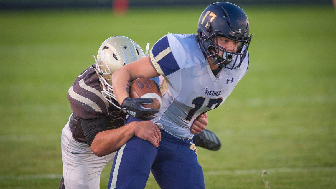 Middleton’s Jake Tuckett tries sneak free from a Vallivue tackle Oct. 12.