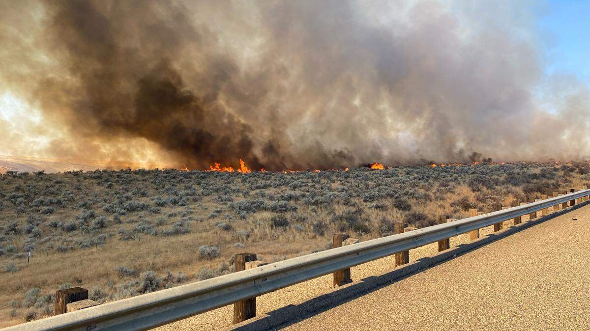 A wildfire burning along Interstate 84 in Oregon has shut down the highway in both directions between Ontario and Baker City.