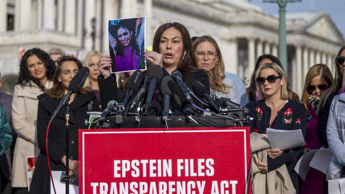 Epstein survivor Haley Robson (C) holds up a photo of her younger self during a news conference on the Epstein Files Transparency Act at the US Capitol in Washington, DC, on November 18, 2025. US lawmakers are expected to vote Tuesday for the release of government records on sex offender Jeffrey Epstein, in defiance of President Donald Trump's attempts to keep a lid on one of the country's most notorious scandals. (Photo by DANIEL HEUER / AFP) (Photo by DANIEL HEUER/AFP via Getty Images)          