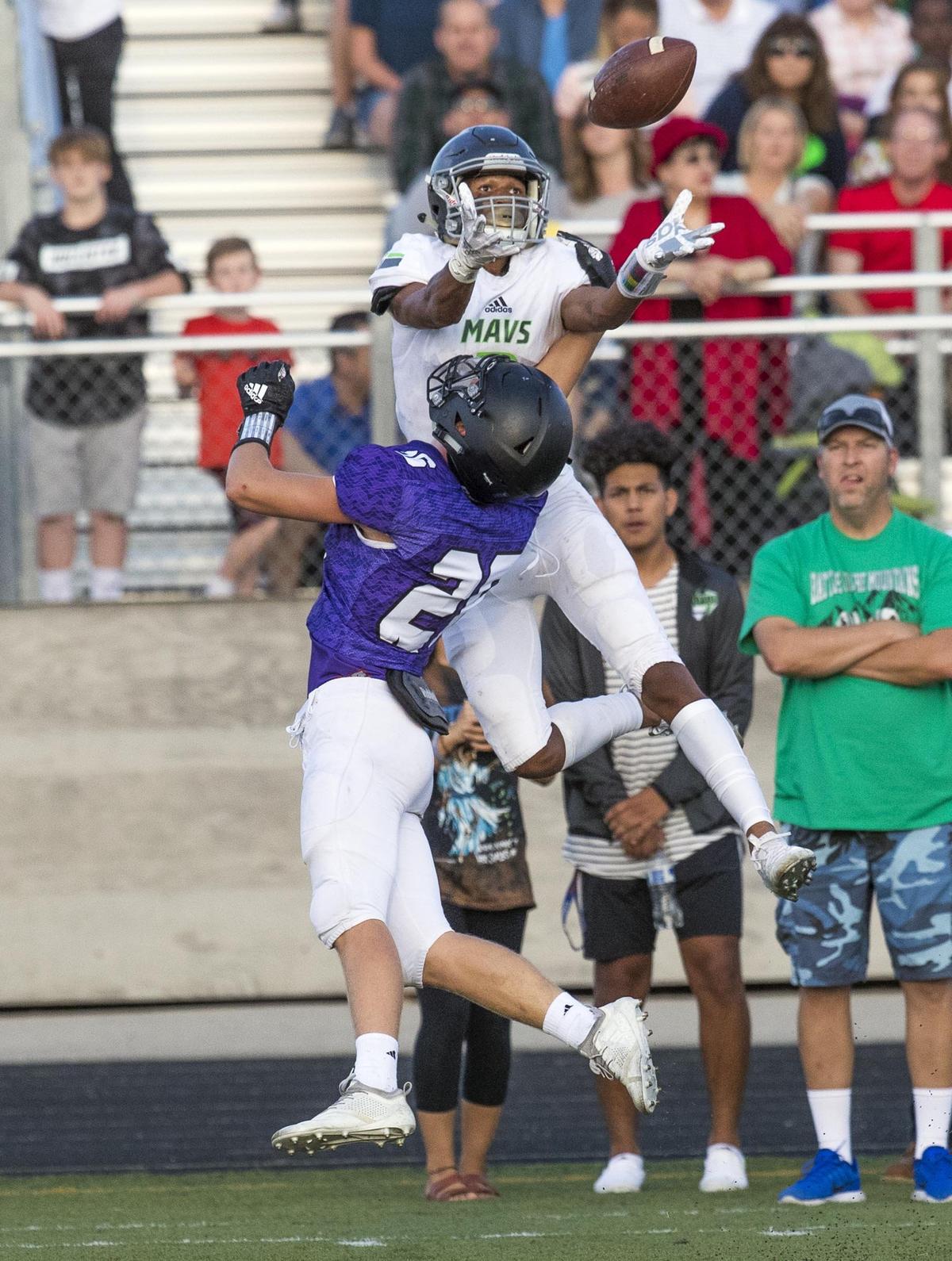 Mountain View wide receiver K.J. Lynch leaps up for a pass over Rocky Mountain’s Brayden Rundell on Sept. 25 at Rocky Mountain High School in Meridian.