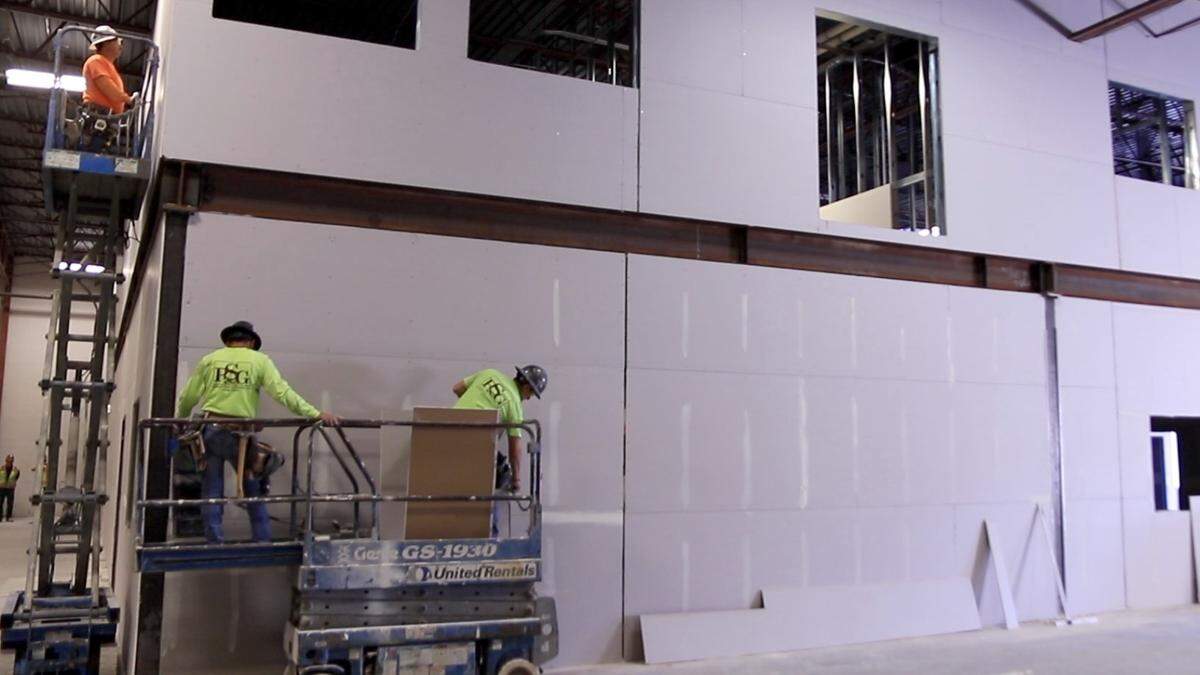 Workers renovate the Idaho Foodbank’s next headquarters and warehouse, the former Capitol Distributing warehouse on East Commercial Court in Meridian. Capitol Distributing has moved to Caldwell. The Foodbank plans to move from Boise into this building this fall.