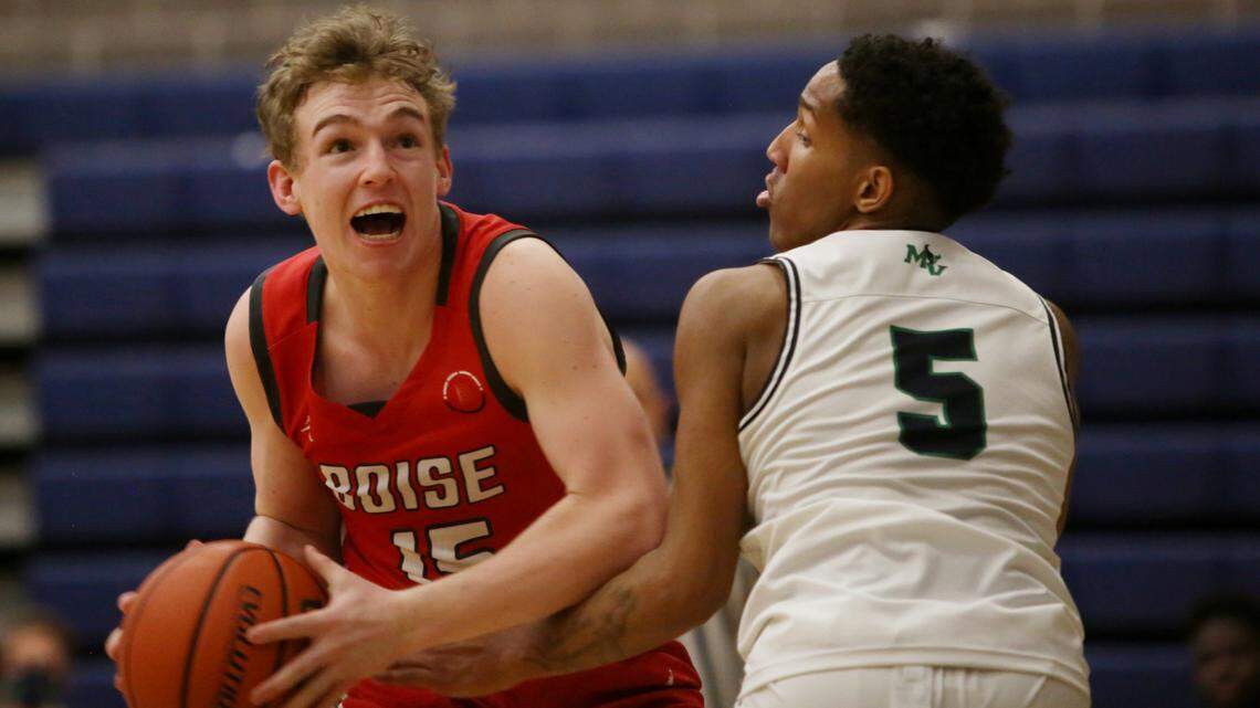 Boise’s Cooper Howell makes a move toward the basket while guarded by Mountain View’s Noah White on Tuesday at Mountain View High in Meridian.