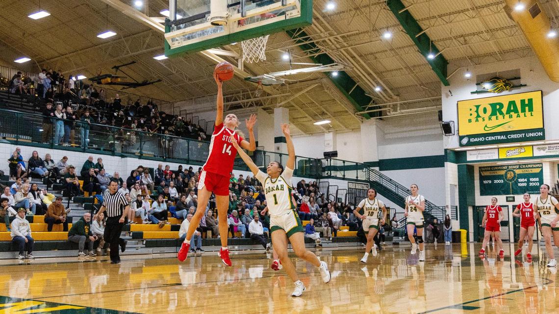 Owyhee senior Riley Beck gets past Borah defender Karli Hall to score during their basketball game Tuesday at Borah.