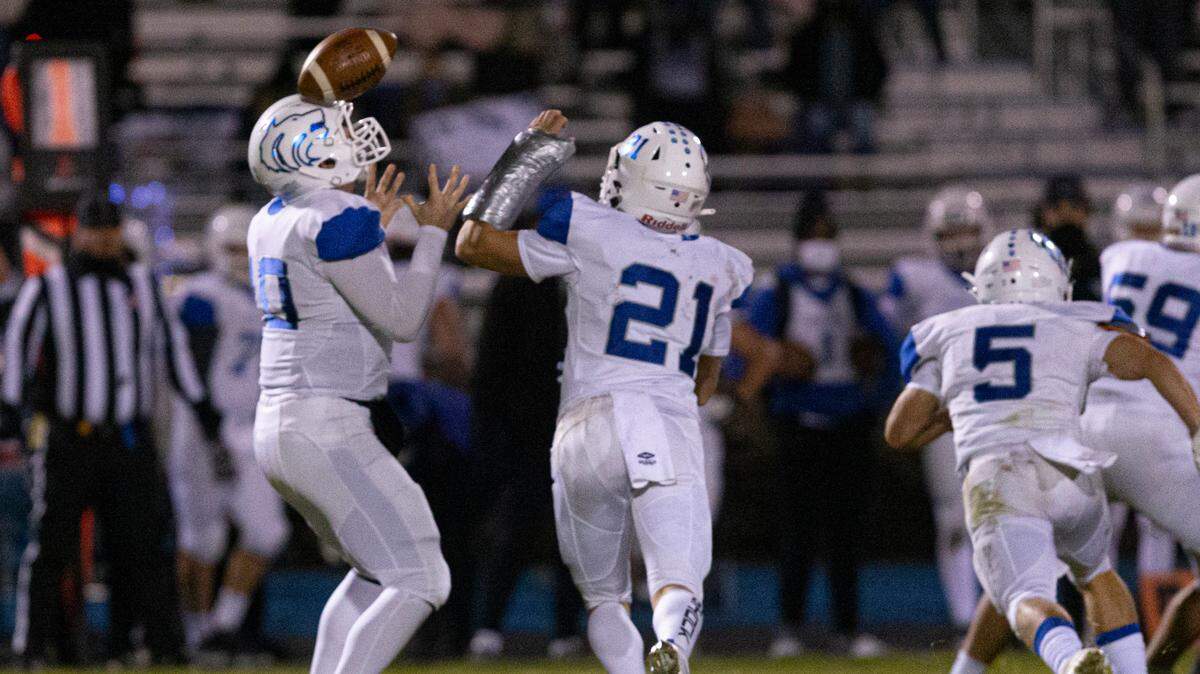 Timberline quarterback Max Spielman tries to corral a snap over his head Friday in the Wolves’ 56-7 loss at Coeur d’Alene.