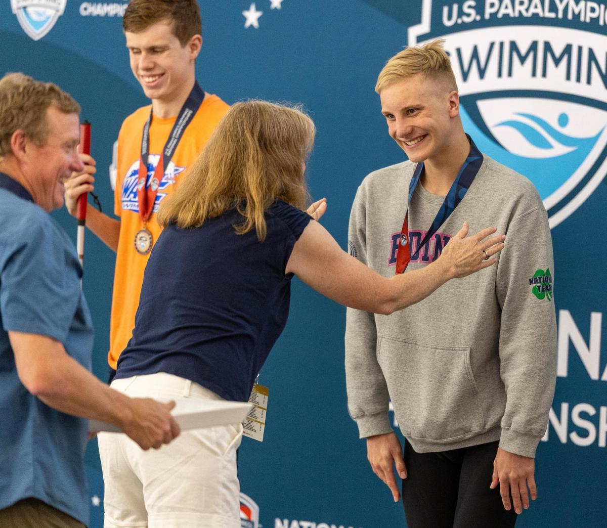 Koehn Boyd receives a first-place medal for the men’s 100-meter butterfly event during the 2025 U.S. Paralympics Swimming National Championships on Friday in Boise. More than 60 elite U.S. Paralympic swimmers competed in individual and relay events held at the Idaho Central Aquatic Center.