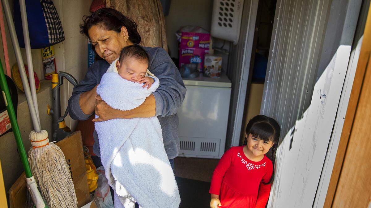 Bertha Nunez holds her 2-month-old grandson while her granddaughter, Camilla, poses for the camera on the porch of the Nunezes’ small trailer house. Nunez and her husband, Daniel, have lived at the North Fork Trailer Park north of Ketchum for 16 years, but are moving this month because the owners are closing the trailer park. They will leave their home behind, she said, because the trailer isn’t structurally sound enough to be moved.