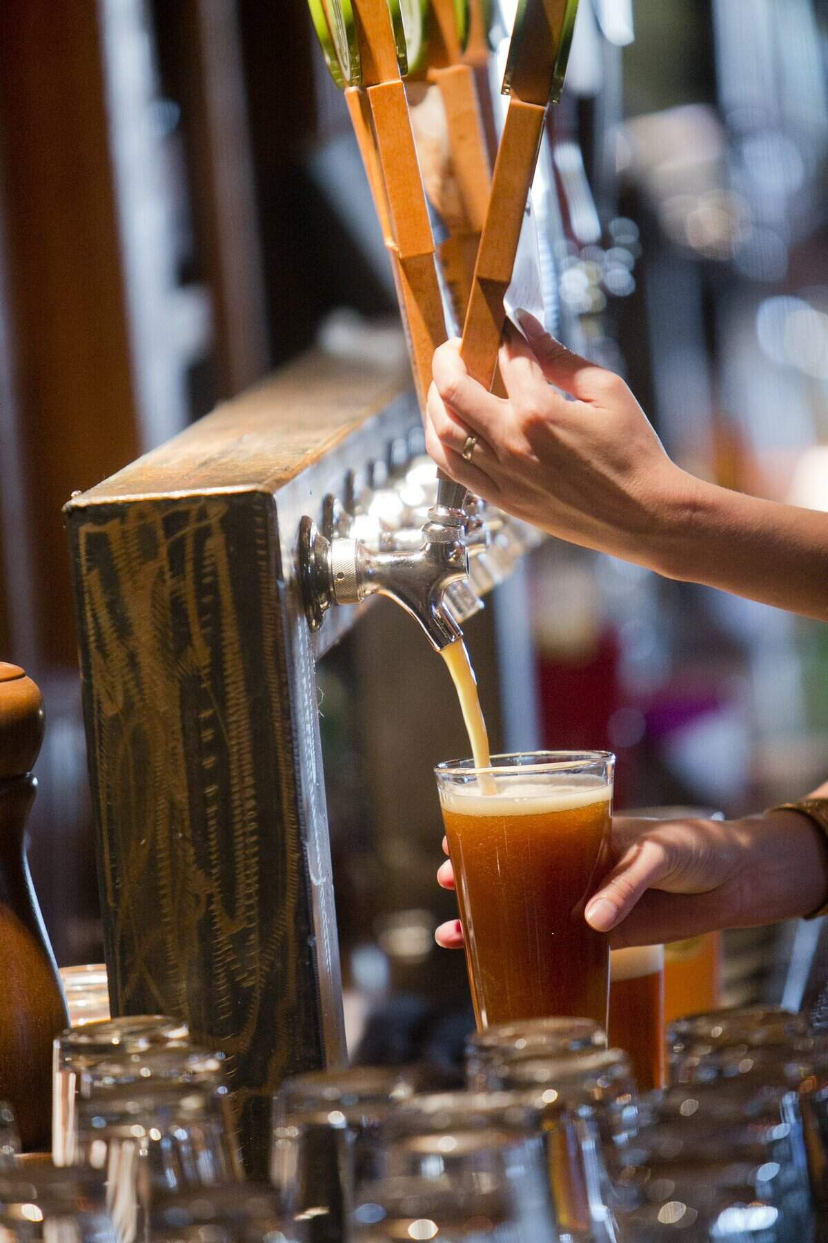 Bartender Amanda Petersen fills a glass with beer at Crooked Fence Barrelhouse in Boise, Idaho. There has been a boom in craft brewpubs in Southwestern Idaho.