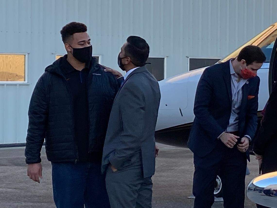 Boise State football coach Andy Avalos is greeted by offensive lineman Donte Harrington after the former defensive coordinator at Oregon arrived in Boise on Saturday.
