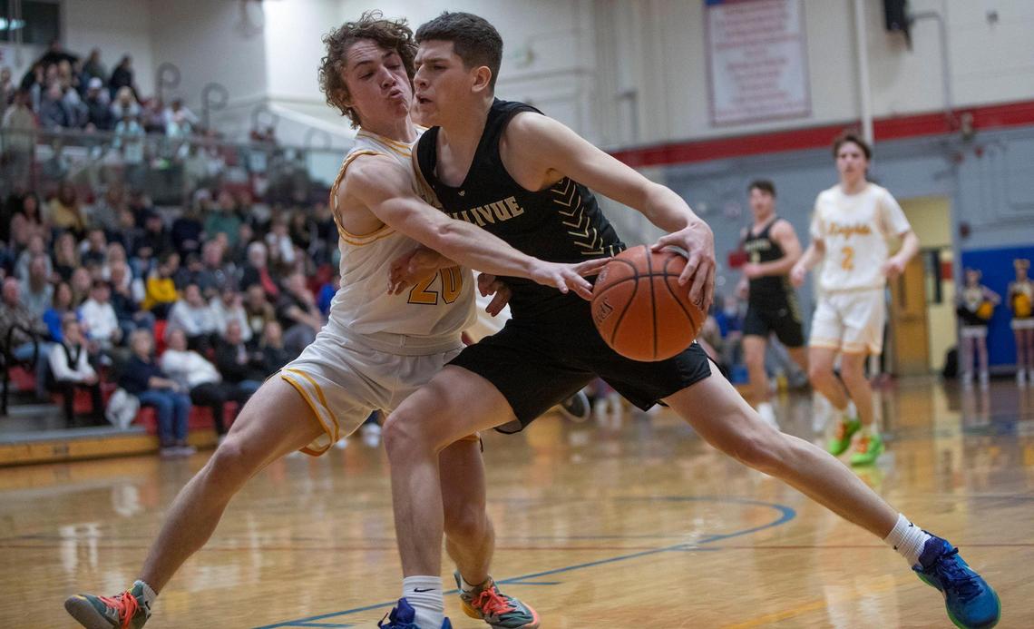 Bishop Kelly sophomore Cooper Cammann pressures Vallivue’s Jacob Martinez in the 4A District Three boys basketball championship Feb. 24 at Nampa High School. Both made the 4A SIC academic all-conference team.