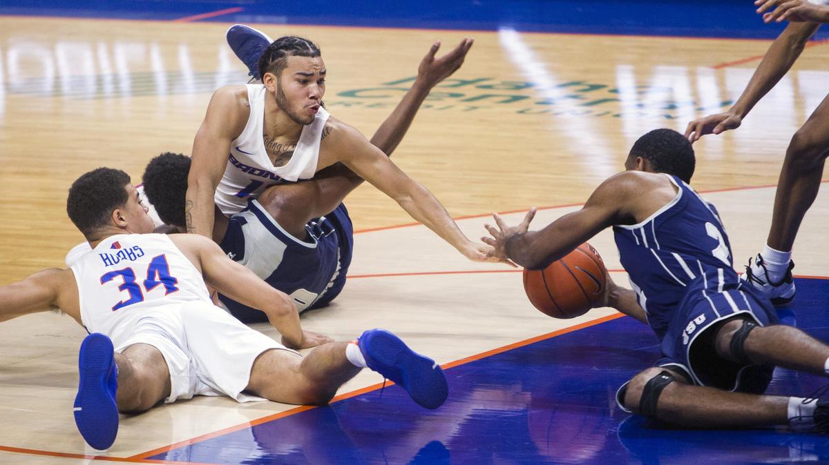 Boise State guard Pat Dembley dives for a loose ball with teammate Alex Hobbs against Jackson State on Nov. 16, 2018, at Taco Bell Arena in Boise.