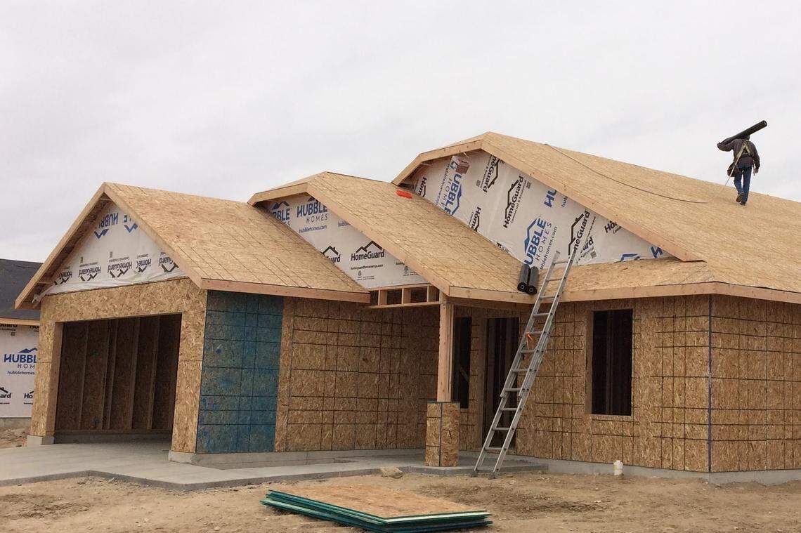 A roofer works on a house going up in February on Romae Street in a new Hubble Homes subdivision west of Middleton Road and north of Orchard Avenue in western Nampa.