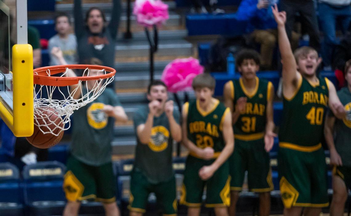 Borah’s bench celebrates a 3-pointer by teammate Ray Ray Bergersen in the second Jan. 31 at Meridian High School.