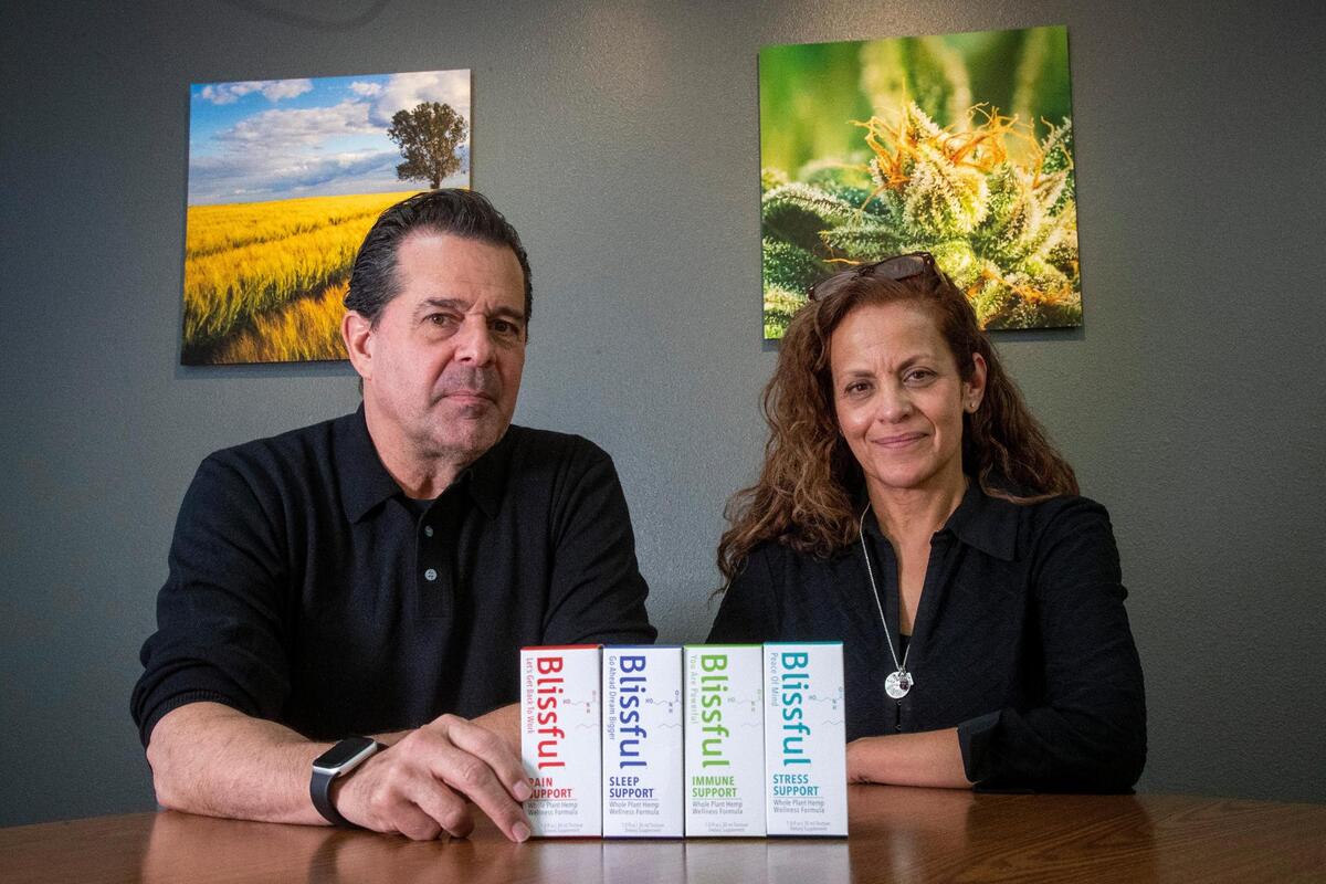 Paul Frantellizzi and Pamela Peters, owners of The Blissful Plant Co., have to pose for photos with empty boxes of their products. Because items containing any amount of THC are illegal in Idaho, the company cannot bring them into the state.