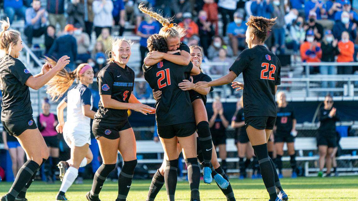 Boise State players celebrate freshman Carly Cross’ game-winning goal in the 43rd minute Thursday at the Boas Soccer Complex. The Broncos defeated Utah State 2-1.
