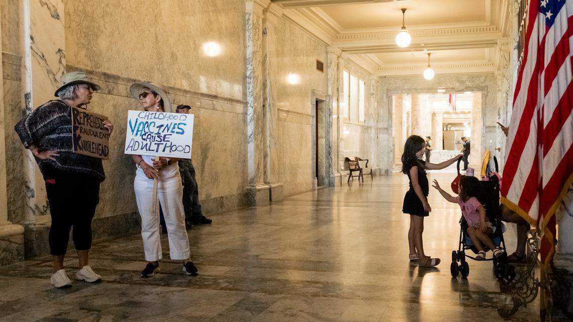 Demonstrators hold signs outside Gov. Brad Little's office in the Idaho Capitol in Boise, Idaho on July 23, 2025. Gov. Little was about to host Secretary of Health and Human Services Robert F. Kennedy Jr. for brief remarks to media and a MAHA-related proclamation by the governor. (Otto Kitsinger for ProPublica)