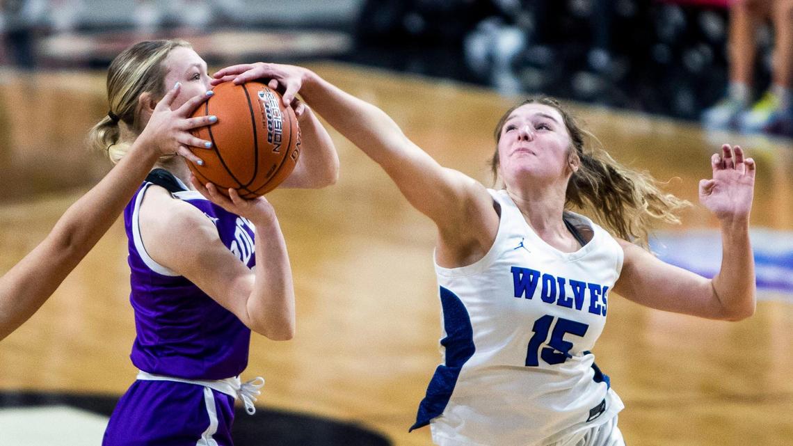 Timberline senior Kailey Huegerich blocks a shot by Rocky Mountain’s Logan Sailors on Friday. Rocky Mountain won 55-52 in overtime to advance to Saturday’s 5A state championship against Coeur d’Alene.