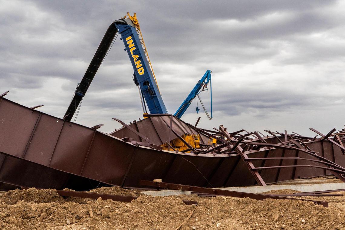 At the construction site where a building collapsed Wednesday near the Boise Airport, wreckage shows twisted girders with a crane in the center. Three workers died at the scene and nine others were injured. The project was an airplane hangar for Jackson Jet Center.