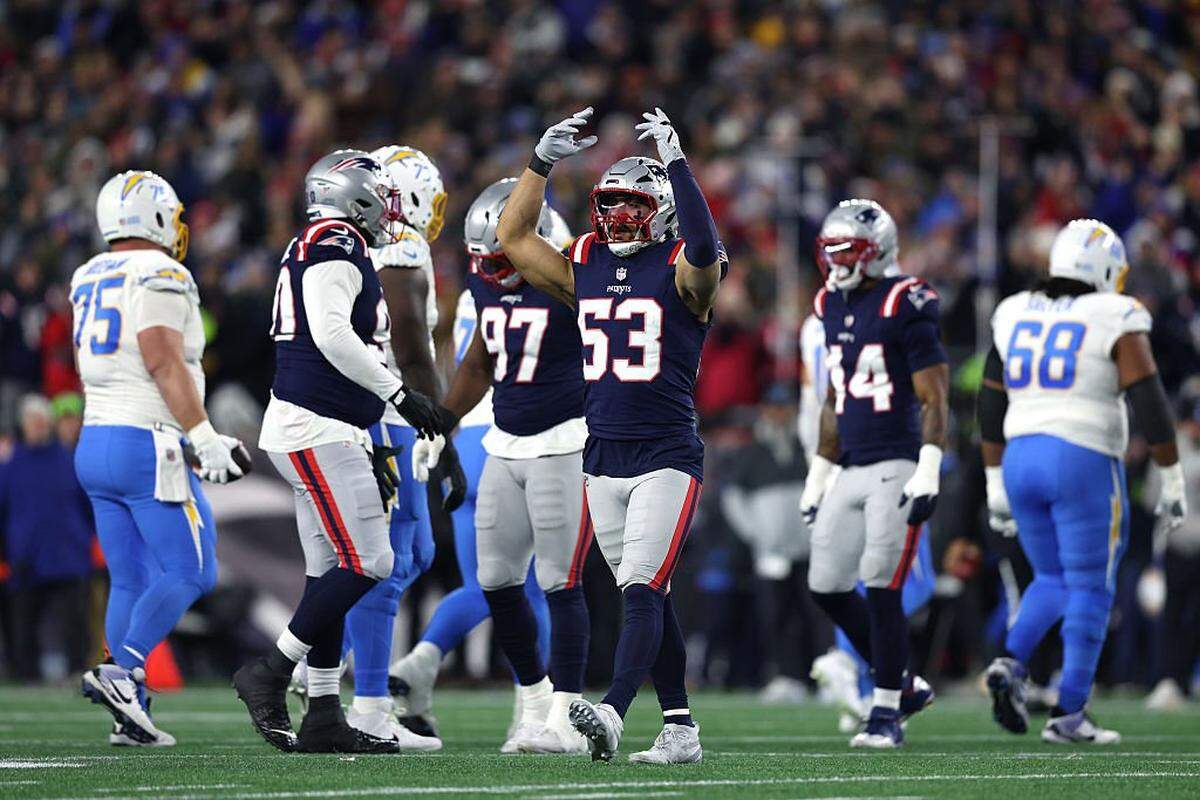 New England’s Christian Elliss, center, reacts after a play against the Los Angeles Chargers during their AFC playoff win on Jan. 11 at Gillette Stadium in Foxborough, Massachusetts.