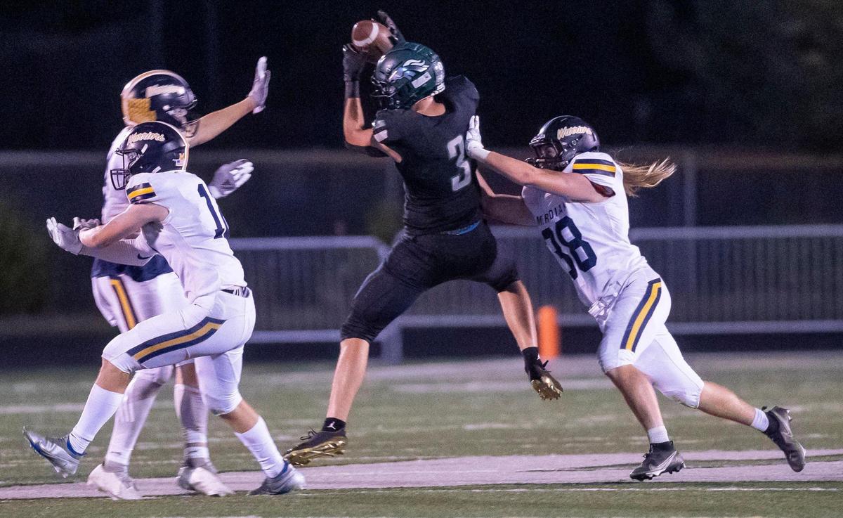 Eagle tight end Donovan Jones pulls in a 28-yard catch on fourth-and-15 late in the fourth quarter Friday.