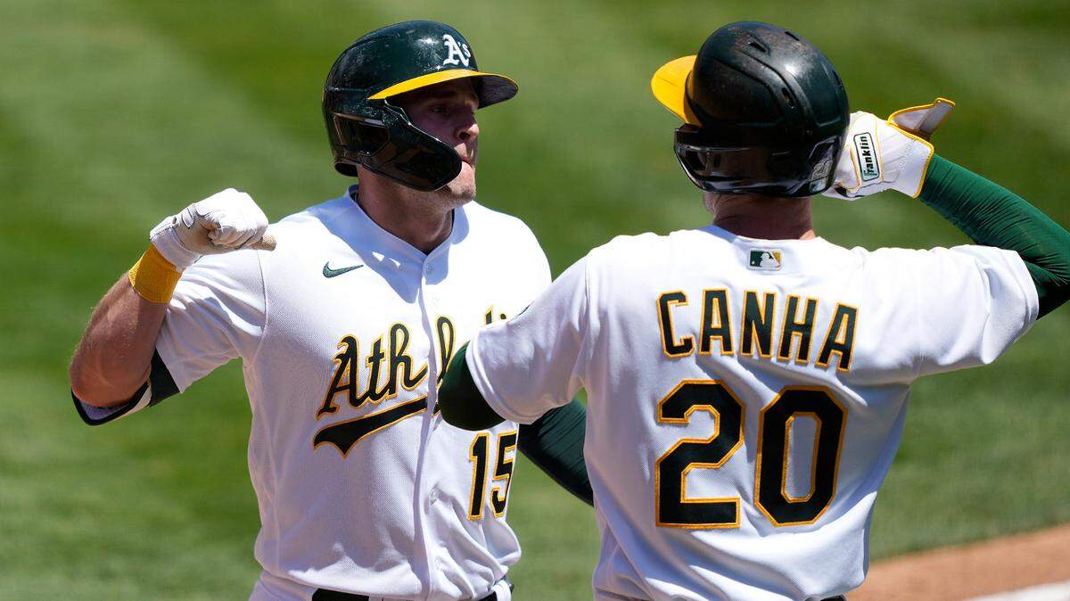 Former Lewis-Clark State College star Seth Brown, left, has become an everyday player for Oakland this season. Above, he’s congratulated by teammate Mark Canha after hitting a two-run home run May 8.