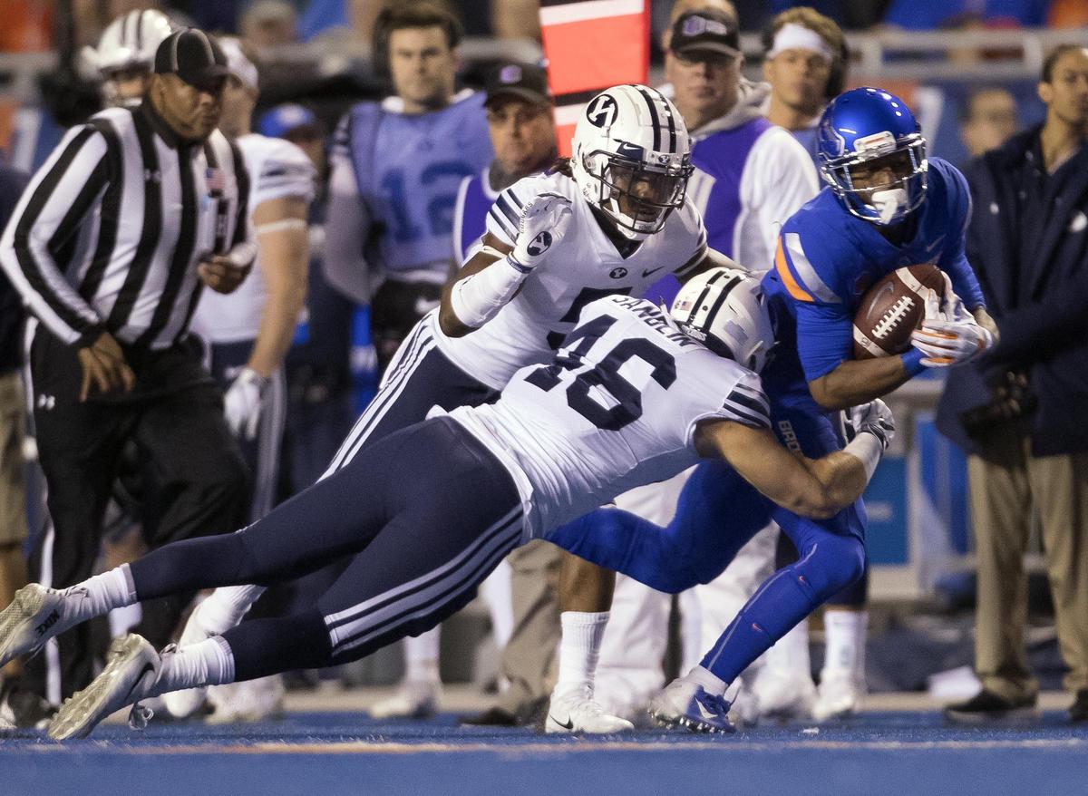 Boise State wide receiver Akilian Butler (81) gains a first down on a catch defended by Brigham Young linebacker Rhett Sandlin (46) and defensive back Dayan Ghanwoloku (5) Saturday Nov. 3, 2018 at Albertsons Stadium in Boise.