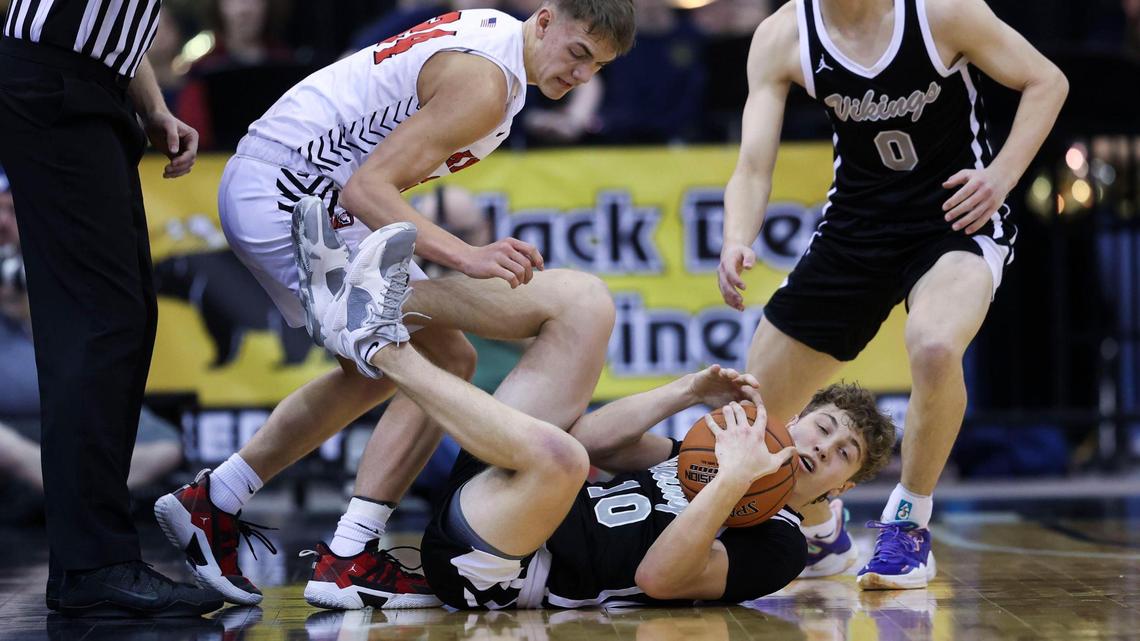 Middleton guard Talmage Stucki grabs a loose ball in a scramble with Hillcrest’s Kobe Kesler in the first half of their 4A state tournament semifinal game Friday at the Ford Idaho Center in Nampa.