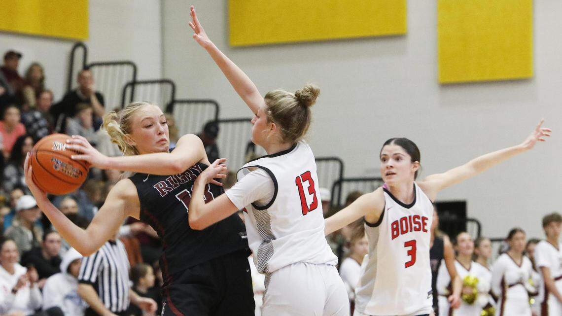 Boise’s Avery Patricco, center, and Sophia Clark pressure Rigby’s Mylee Graham in the backcourt in the 5A girls basketball state third-place game at Bishop Kelly.
