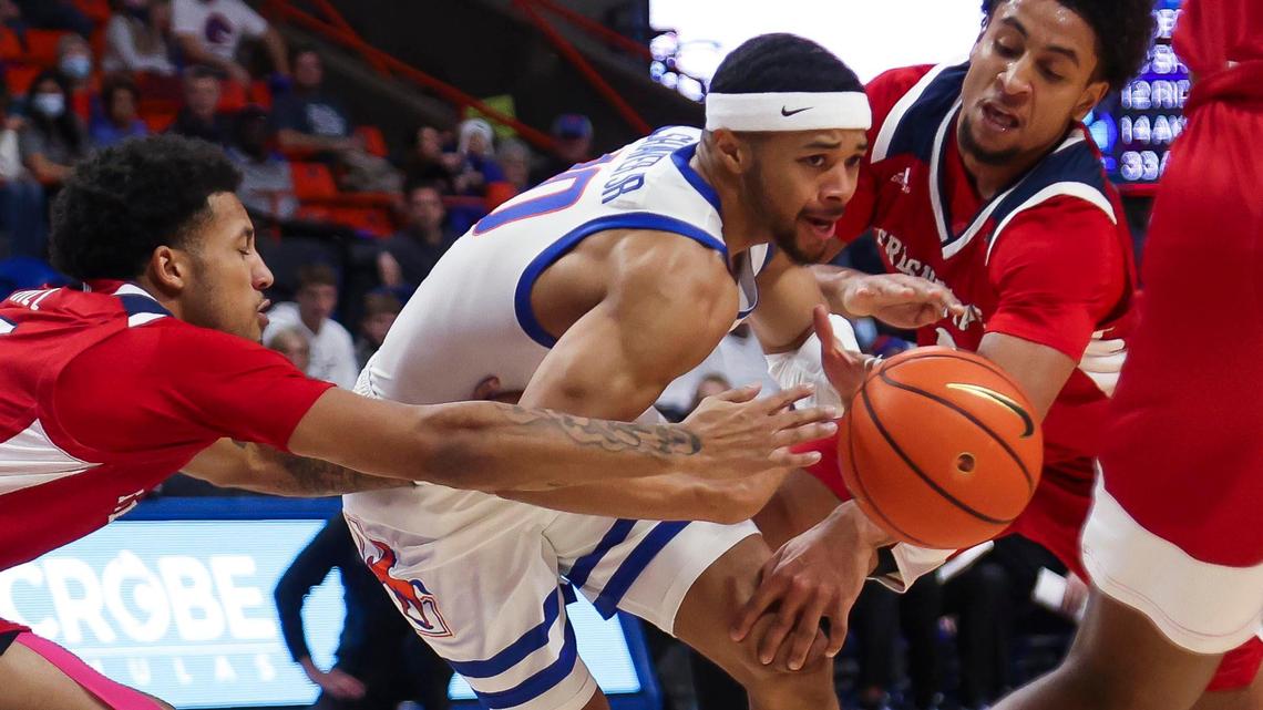 Boise State guard Marcus Shaver Jr. feels pressure from Fresno State guards Junior Ballard and Isaiah Hill on a drive in the first half of the Broncos’ Mountain West Conference opener Dec. 28 at ExtraMile Arena in Boise.