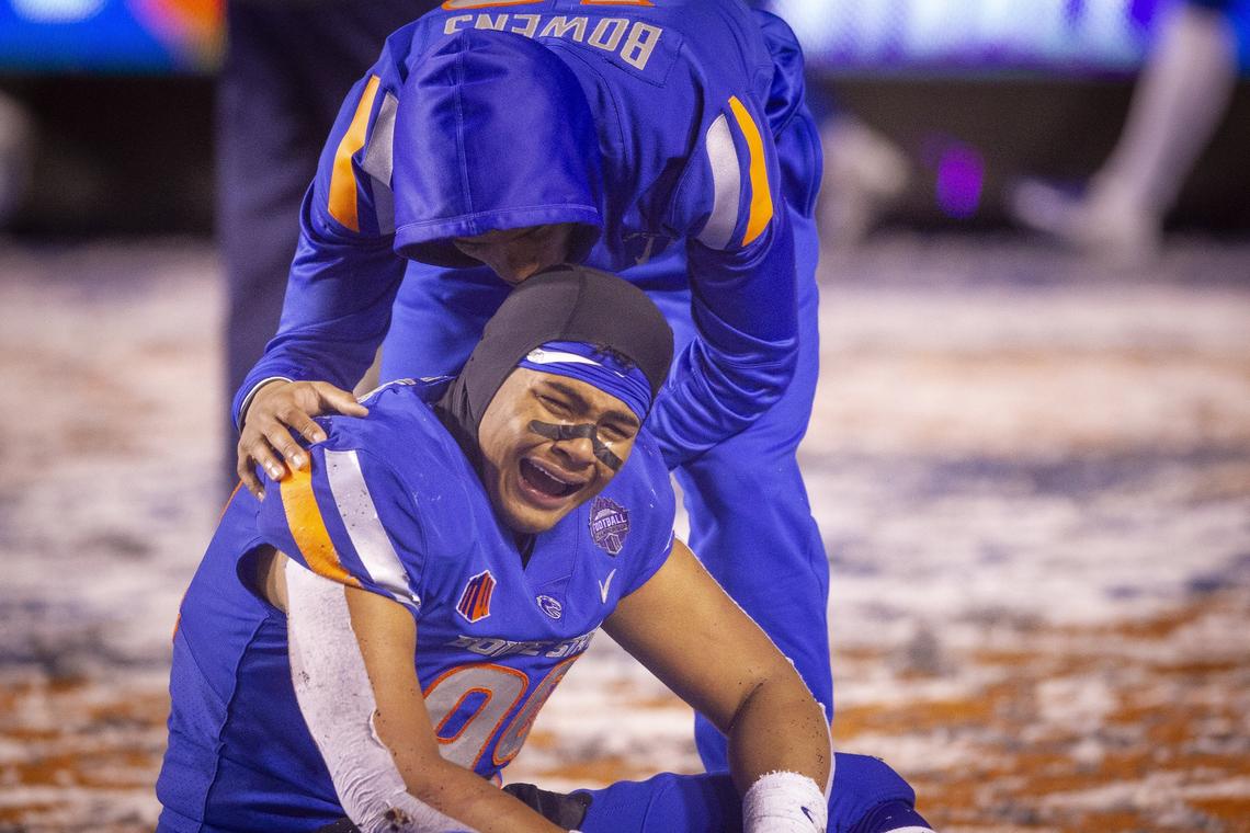 Boise State STUD end Curtis Weaver was comforted by teammate Billy Bowens after the Mountain West championship game last year at Albertsons Stadium. Fresno State defeated Boise State 19-16 in overtime.