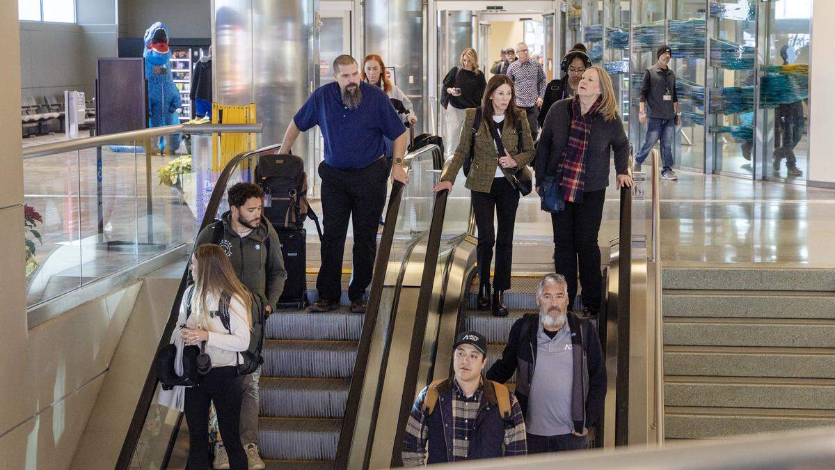 People exit the secure area of the Boise Airport and take the escalator to the first floor for luggage and transportation, Dec. 16, 2025.