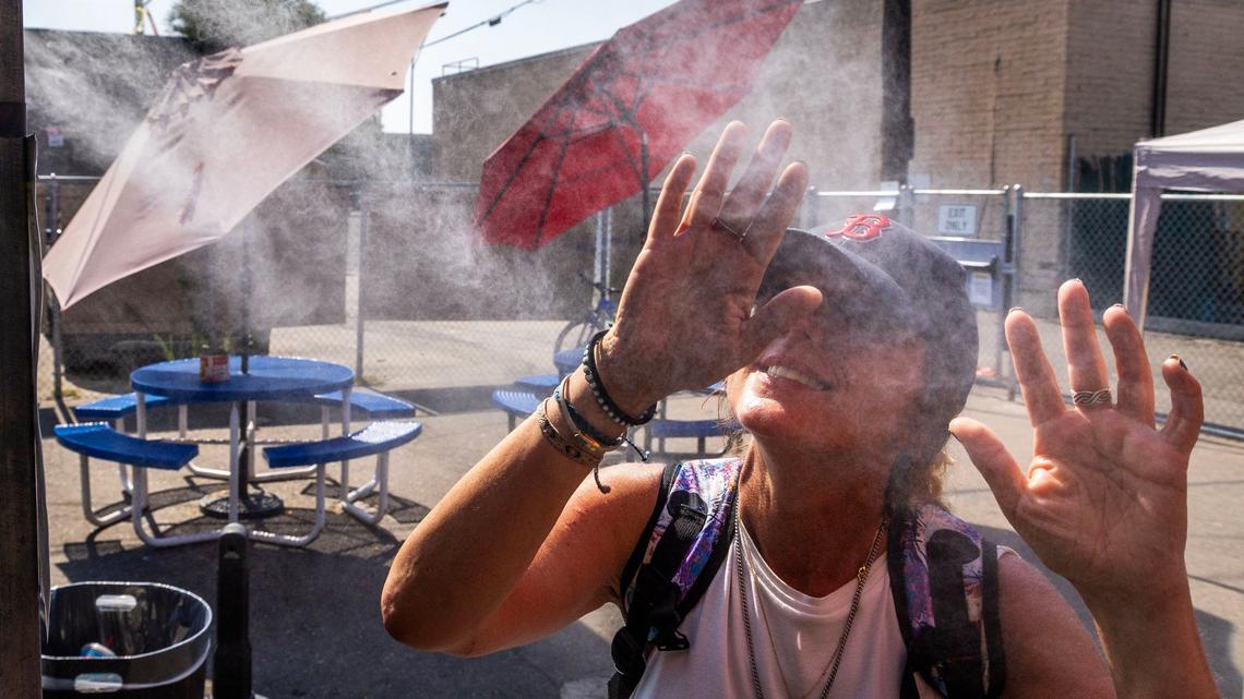 Melisa Cannon enjoys the cool water misters installed by Boise company Mr. Misters at Corpus Christi House.