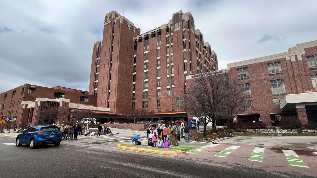Protesters gather outside of St. Luke’s Boise Medical Center on March 15, 2022, holding signs and shouting at Boise police who responded as the medical facility went into a security lockdown. Far-right activist Ammon Bundy, who was arrested for trespassing at the St. Luke’s Meridian hospital, called for the protest via social media video.
