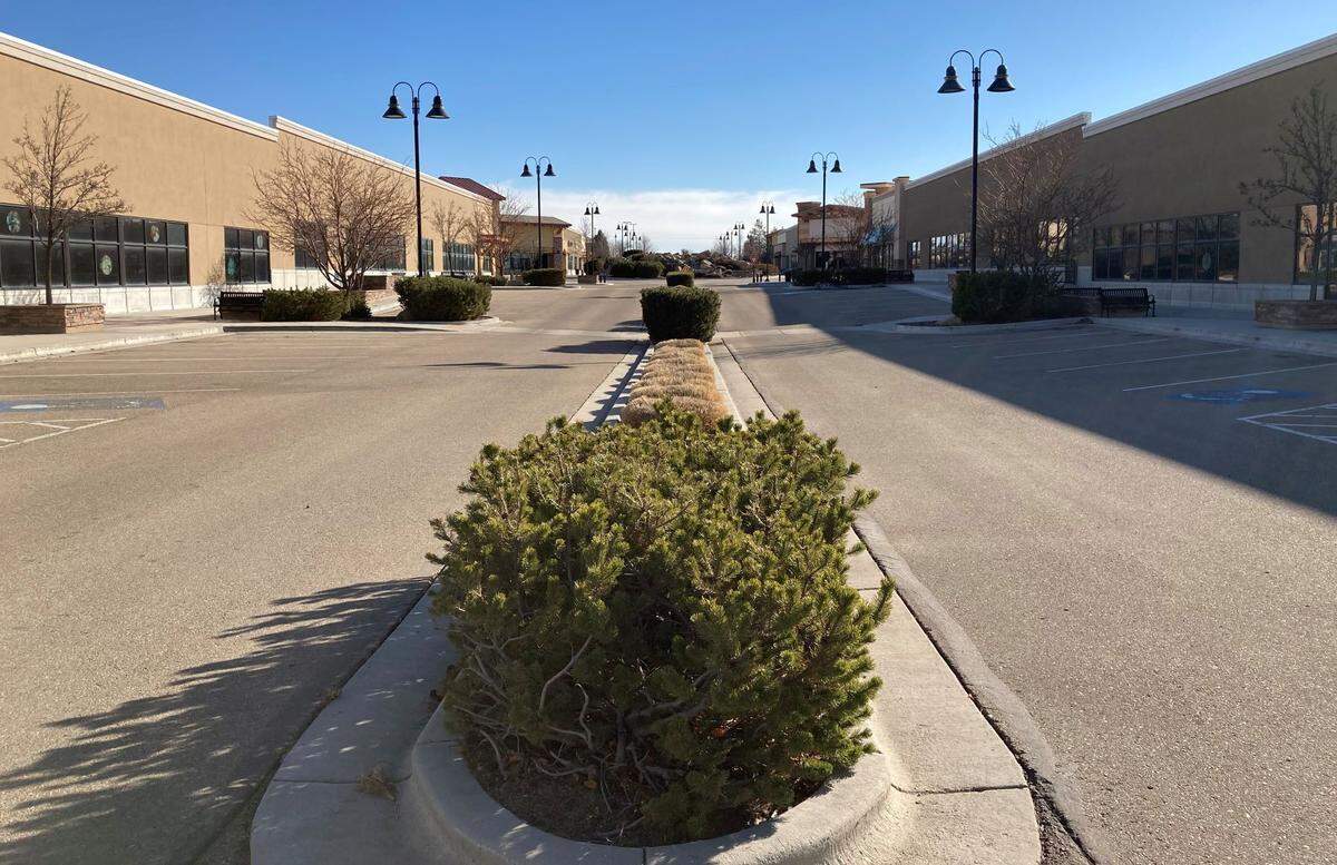 A street in the heart of the Nampa Gateway Center with vacant retail spaces on each side.