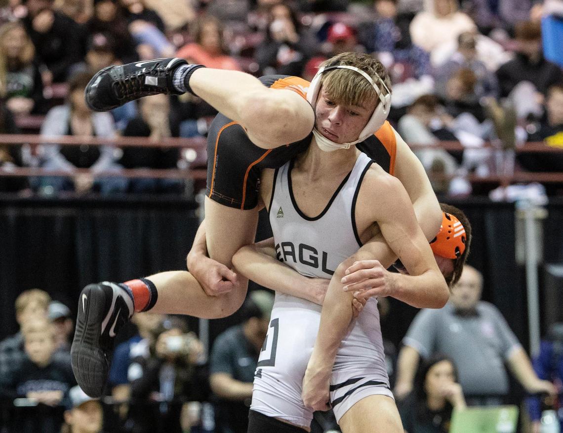 Eagle’s Tanner Frothinger lifts Tyson Barnhart of Post Falls during the 120-pound title match at the Rollie Lane Invite on Saturday at the Ford Idaho Center.