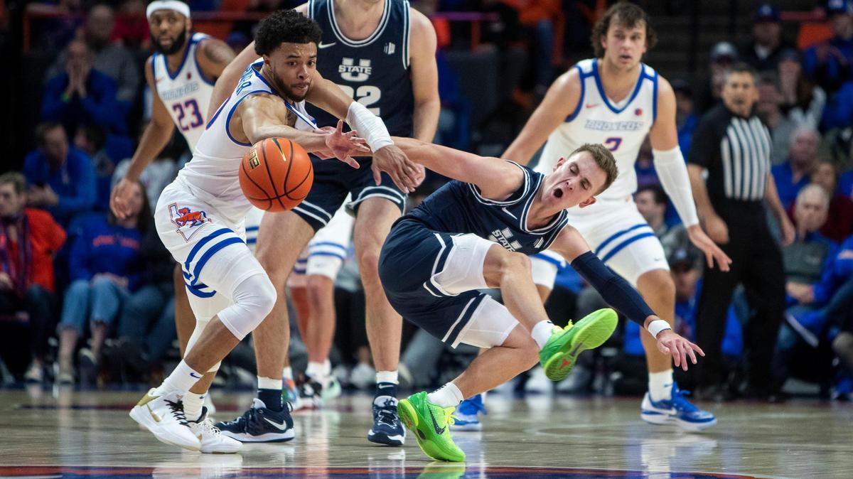 Boise State guard Marcus Shaver Jr. attempts a steal at midcourt but fouls Utah State guard Steven Ashworth in the first half Saturday at ExtraMile Arena in Boise.