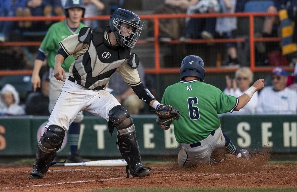 Mountain View base runner Braxton Mills slides safely into home plate ahead of a throw to Capital catcher Cooper Leaf during the state 5A baseball championship Saturday, May 18, 2019 at Memorial Stadium in Boise.