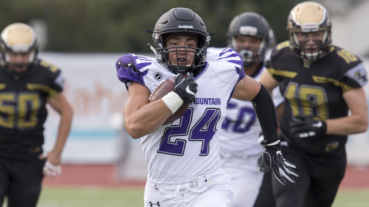 Rocky Mountain’s Nick Romano breaks free for a 74-yard touchdown run on the third play from scrimmage during the Grizzlies’ 50-17 rout of Capital at Dona Larsen Park on Friday.
