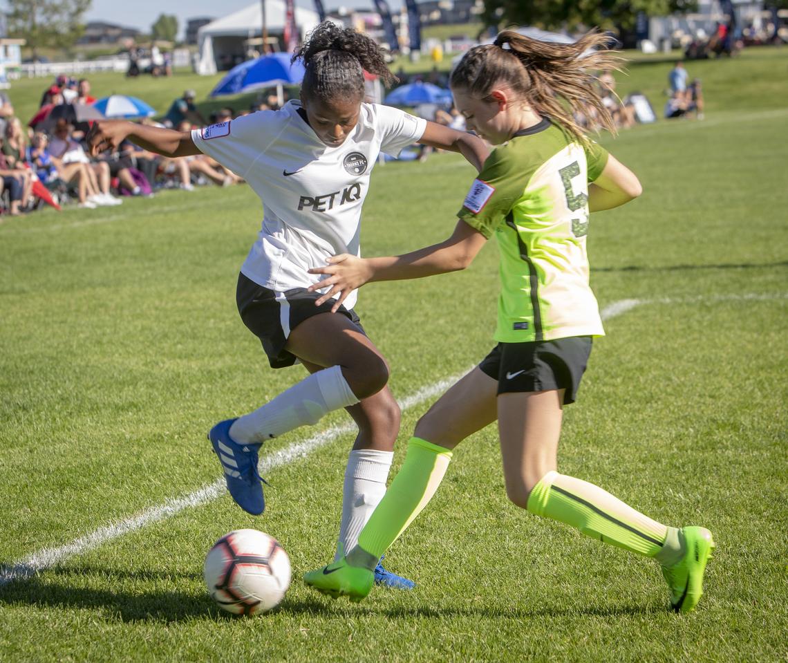 Asia Lawyer, left, tangles with Tyli Tysdal from Colorado Rapids FC during a U-14 game at the Far West Regionals on Monday at the Simplot Sports Complex.