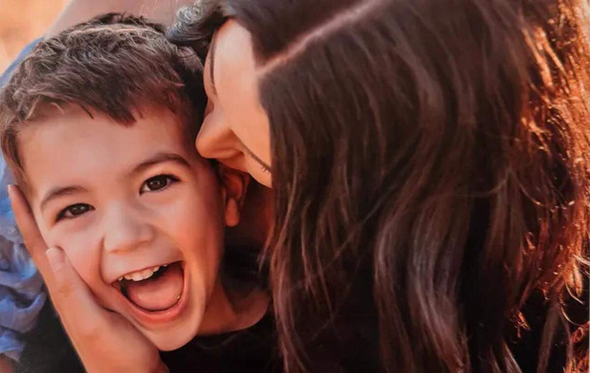Ashley Summers embraces Graham Summers, one of her sons.