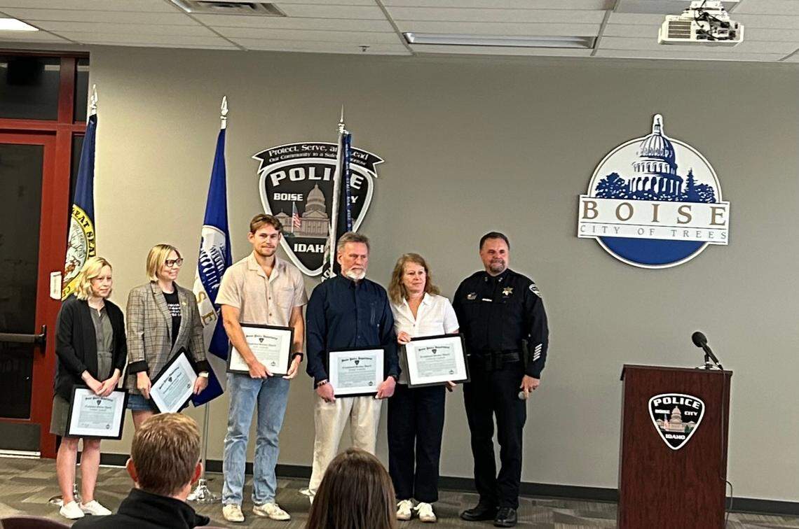 On Friday, Boise Police Chief Ron Winegar, right, honored bystanders, including a visiting emergency room doctor, who provided lifesaving aid to two victims of a hit-and-run in June. From left: Summer Szumski, Anna Hoskins, Jake Szumski, Frank Szumski, and the mother of Zachary Szumski, who accepted the award on his behalf.