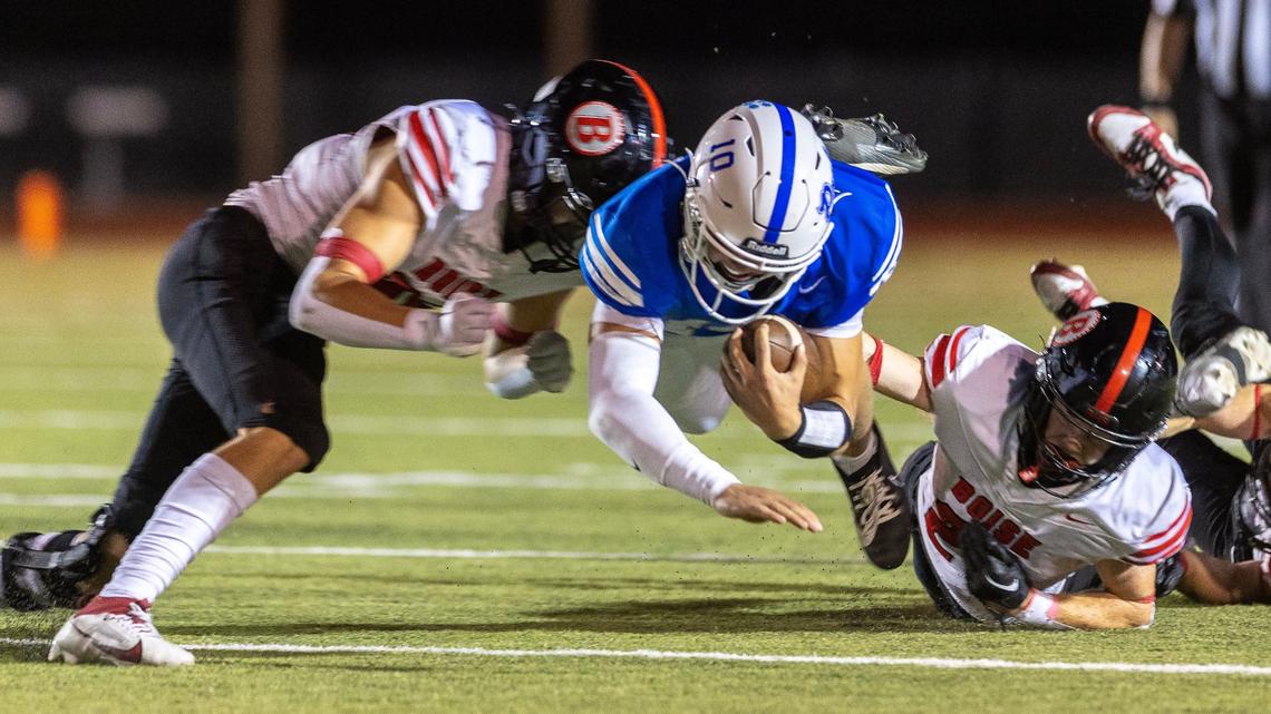 Timberline quarterback Jack Brant is tripped up by Boise defenders in the second half Friday at Dona Larsen Park.