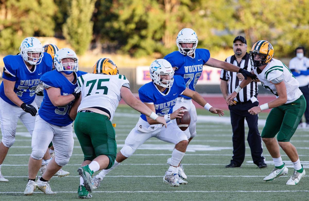 Timberline quarterback Wade Zenner weaves through the Borah defense on Aug. 27.