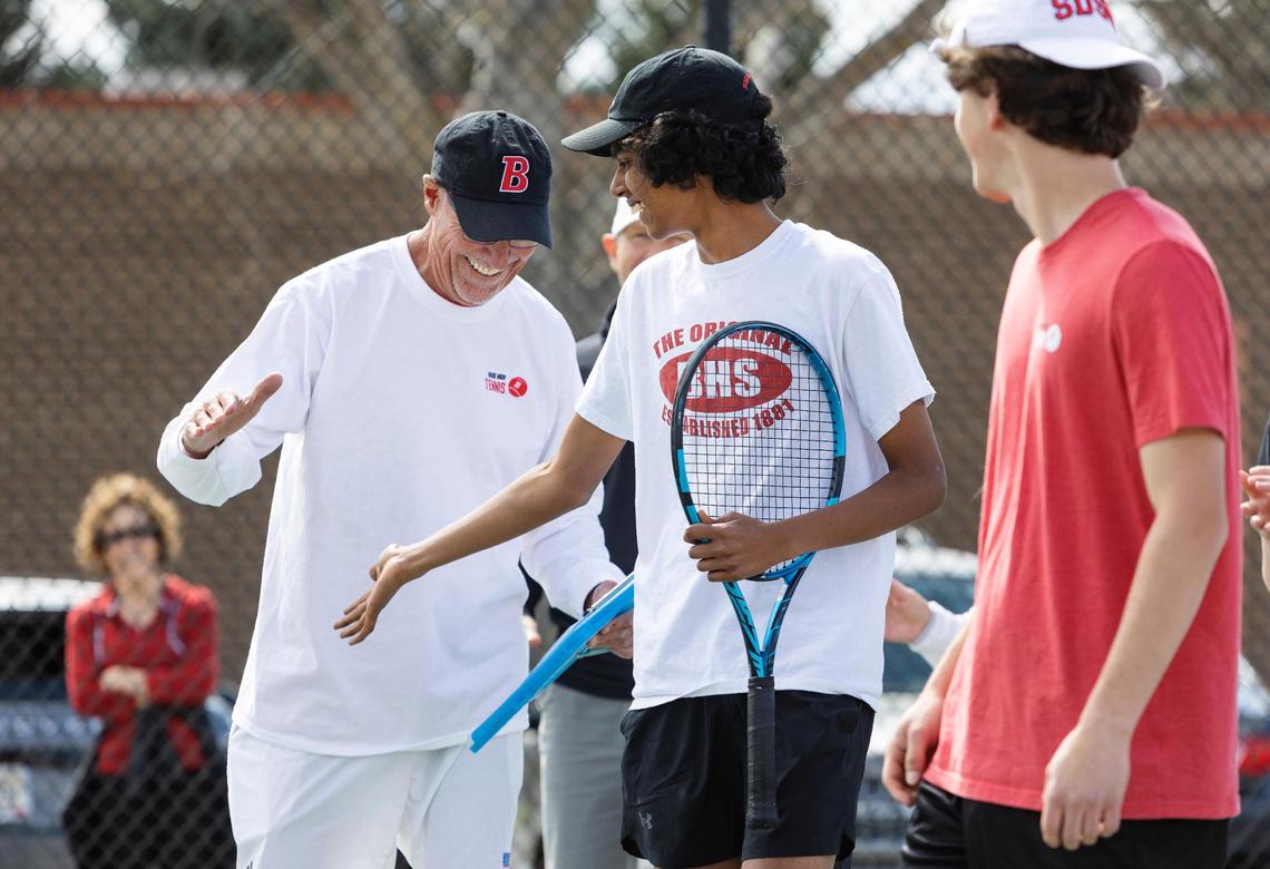 Boise High tennis head coach Greg Patton gives a high-five to Vedant Ranganathan during player introductions at their match against Borah High School on April 20.