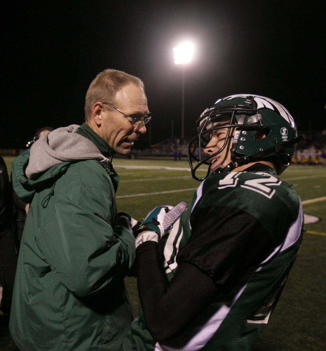 Eagle coach Paul Peterson celebrates a touchdown with Jacob Johnston during a 2008 game.