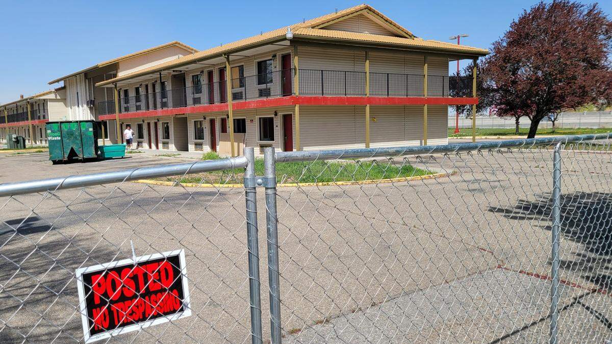 A fence rings the former Howard Johnson by Wyndham Boise motel. An Oregon developer wants to convert the guest rooms into efficiency studios.